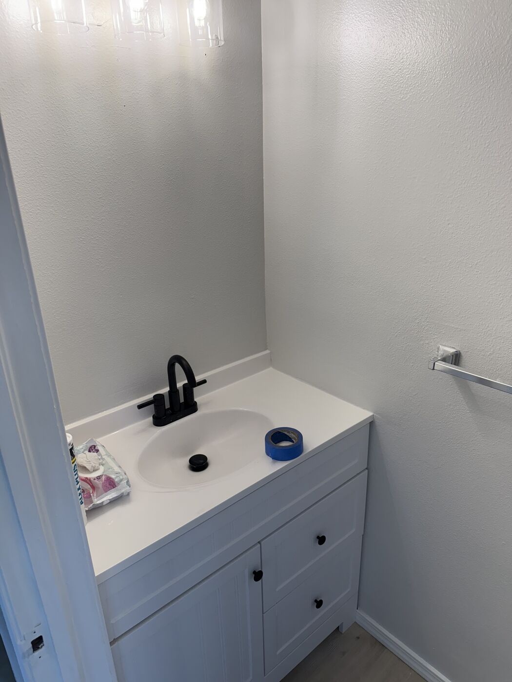 Finished bathroom vanity with a black faucet
