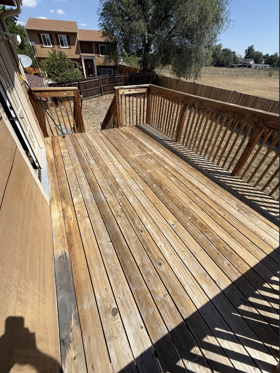 Wood deck sanded back to bare wood with railings, ready for stain