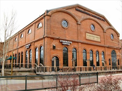 The Denver Tramway Powerhouse exterior during its Starbucks era, showing the arched windows and dark brick facade