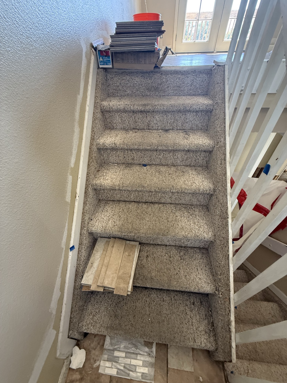 Heavily soiled and stained carpet on a stairway in a Colorado Springs rental after tenant eviction