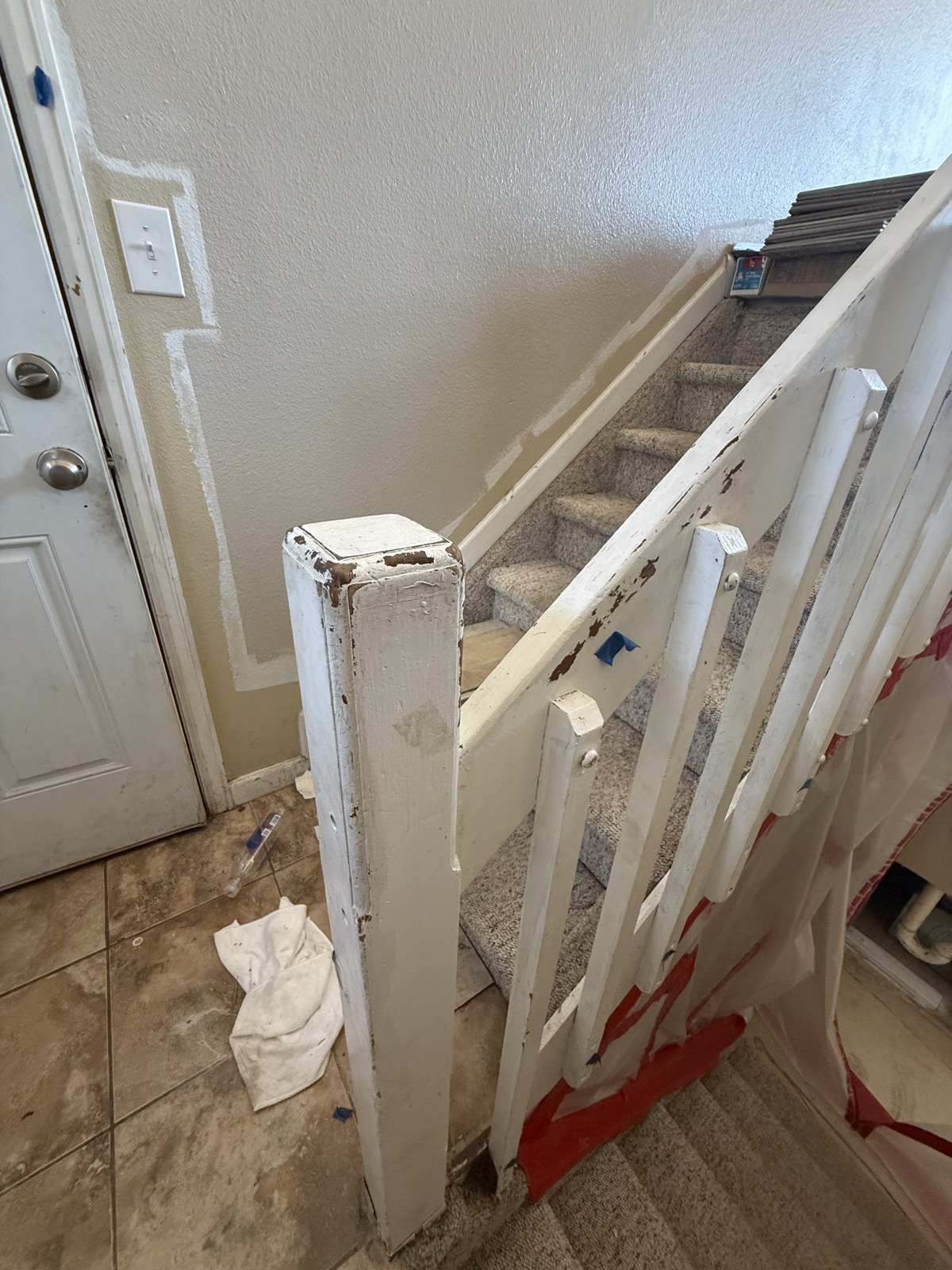 Damaged white stair balusters and handrail pulled loose during a Colorado Springs rental turnover