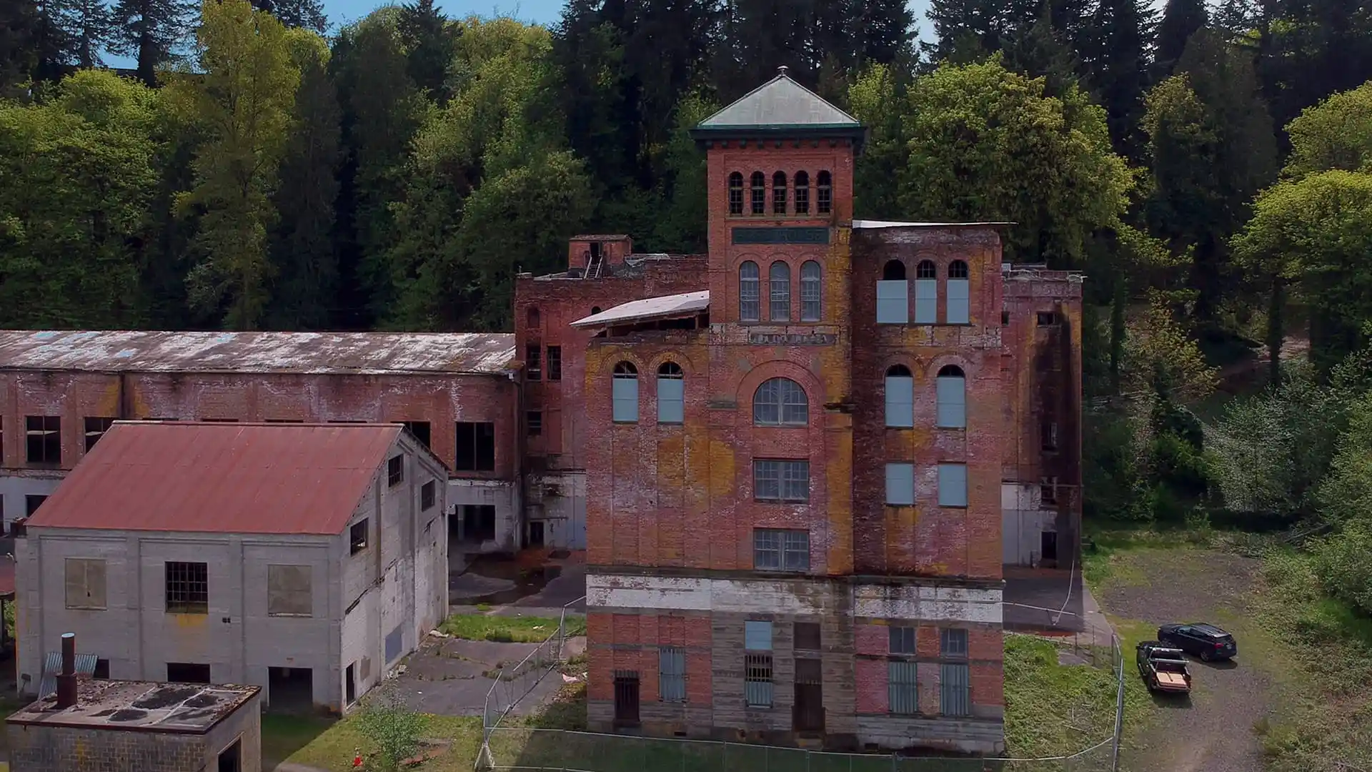 Drone aerial of the Olympia Brewery tower and surrounding derelict outbuildings