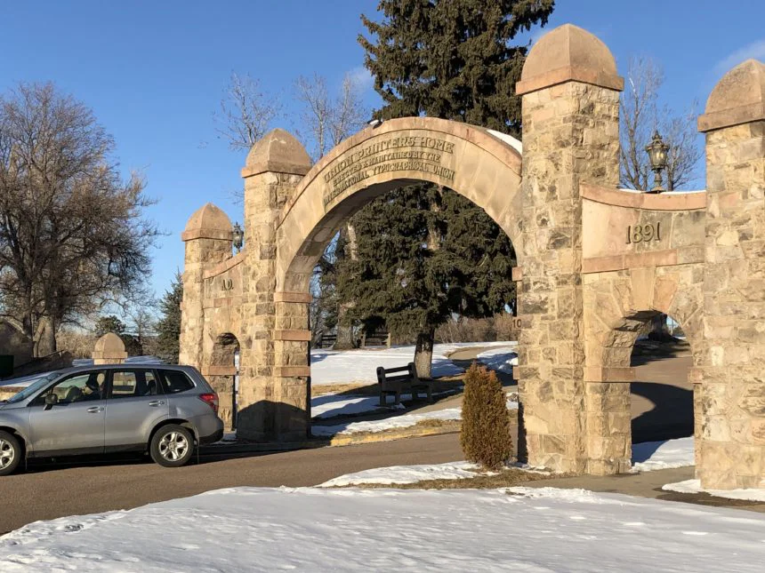 The 1891 sandstone entry arch at the Union Printers Home, Colorado Springs, with snow on the ground